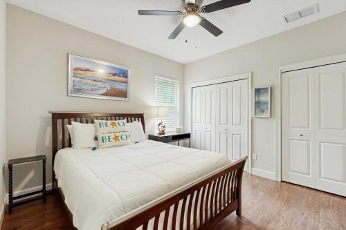 Stylish & sun-filled retreat with large patio & fireplace - near beaches & golf في فرناندينا بيتش: غرفة نوم بها سرير ومروحة سقف