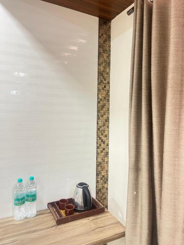 a room with a curtain and two bottles of water at Hotel Bansuri I opposite shreenathji temple 80mtr away 966o9o1oo6 in Nāthdwāra