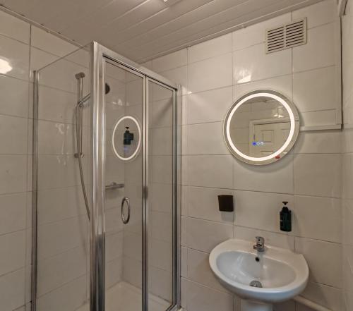ウォルヴァーハンプトンにあるCentral Wolverhampton Stayのシャワー、洗面台、鏡を備えたバスルーム
