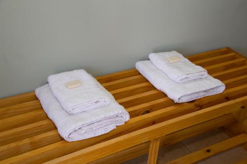 two towels sitting on top of a wooden shelf at Centro Peru in Paraná