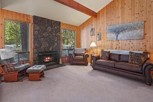 a living room with a couch and a fireplace at 14 Mt Hood Lane home in Sunriver