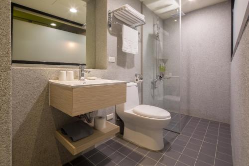 a bathroom with a toilet and a sink and a shower at Cho Hotel in Taipei