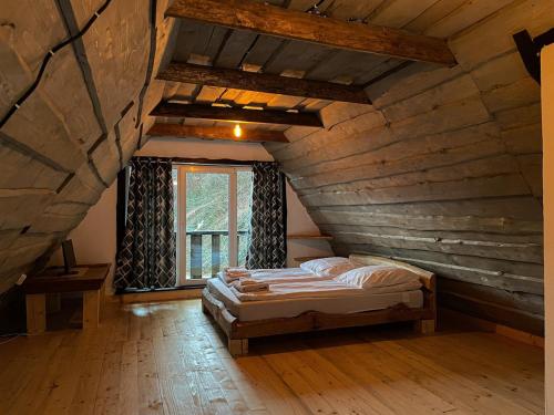 a bedroom with a bed in an attic at Pustirnik in Rakhiv