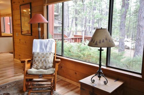 a lamp and a chair in a room with a window at Pet Friendly 8 Leisure Home in Sunriver