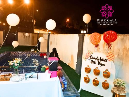 a birthday party with a cake and balloons at DEEJA Homestaycation Kuantan - Enjoy Private Pool by PG Management in Kuantan