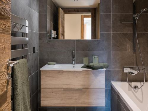 a bathroom with a sink and a mirror at Appartement de Luxe Neuf avec Terrasse au Cœur des Gets, Proche des Pistes et Commerces - FR-1-598-153 in Les Gets