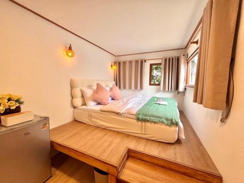 a small bedroom with a bed in a room at Our Time Staycation in Ban Chak Makham
