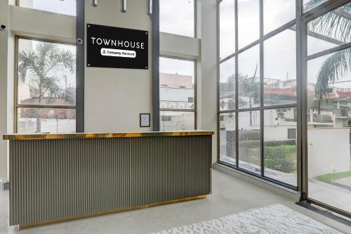 a hotel lobby with a sign that reads town house at Collection O B.R. Ambedkar Park Taramandal Formerly Shree Krishna Inn in Gorakhpur