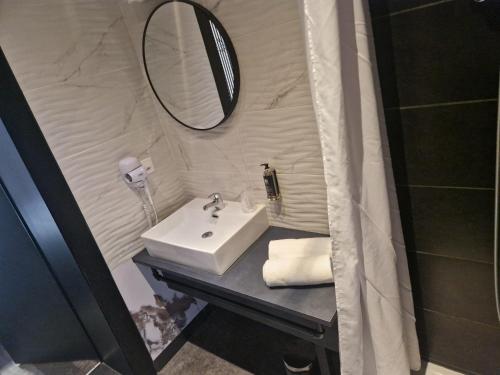 a bathroom with a sink and a mirror at Hotel Parc & Lac in Montreux
