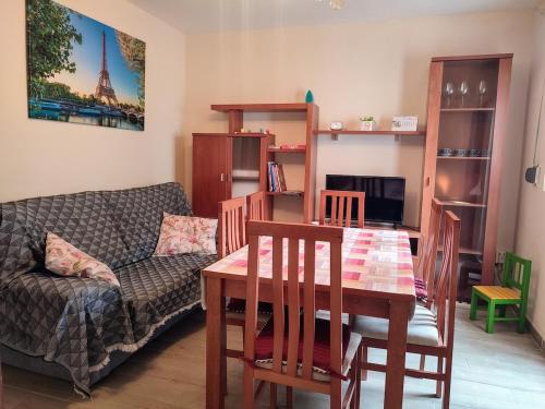 a living room with a table and a couch at GR - Polvorín Oasis in Valladolid