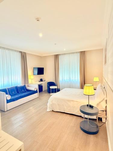 a hotel room with a bed and a couch at Grand Hotel & Riviera in Lido di Camaiore