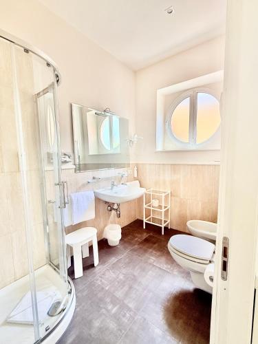 a bathroom with a shower and a toilet and a sink at Grand Hotel & Riviera in Lido di Camaiore