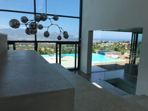 a kitchen with a view of a pool from a house at Luxury Family Home in Helderberg