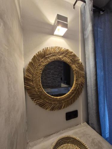 a mirror on the wall of a bathroom at Apomero Apartment in Rochari Panormos in Pánormos