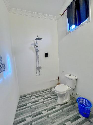 a bathroom with a white toilet in a room at Karibu House Paje in Paje