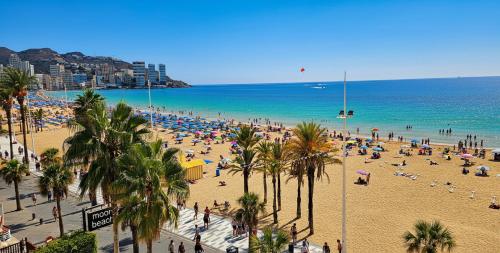 a beach with a lot of people and the ocean at Levante Frontline Luxury Duplex 5 Bedrooms in Benidorm