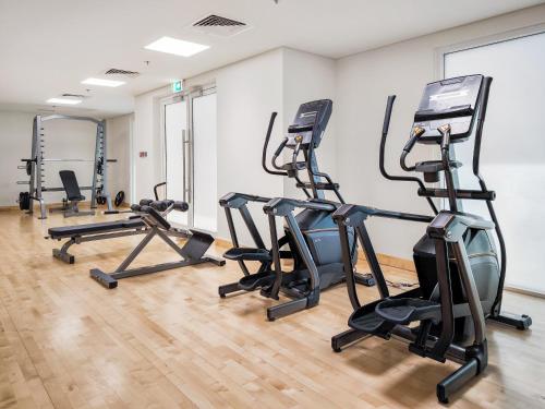 a gym with treadmills and elliptical machines at Desert Key - Perfectly Located Yas Island Premier Apts in Abu Dhabi