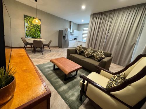 a living room with a couch and a table at Monstera Apartments in Paramaribo
