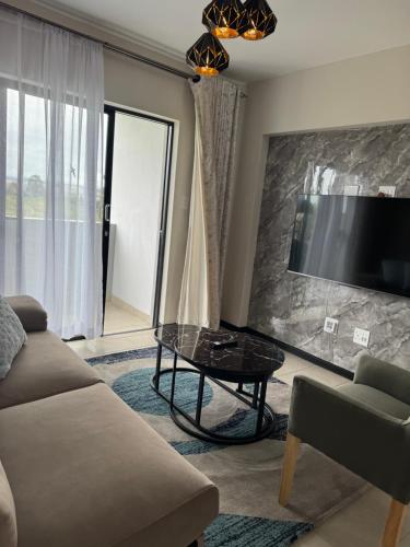 a living room with a couch and a table at Rest & Roam in Bliss in Ballito