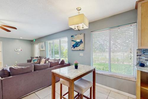 a living room with a couch and a table at Coastal Bliss in Juno Beach
