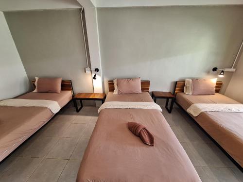 a room with three beds with a shoe on them at Sleep Pai Bed & Breakfast in Pai