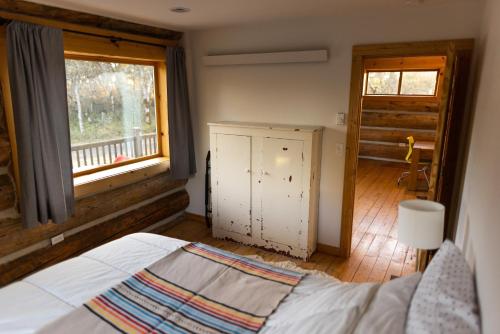 a bedroom with a bed and a window at Adams Rest cabin in The Dalles
