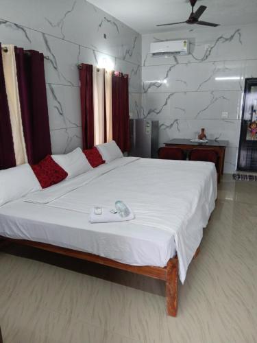 a bedroom with a large white bed in a room at Beach Veedu Home stay near munnodi temple Alleppey Kerala in Alleppey