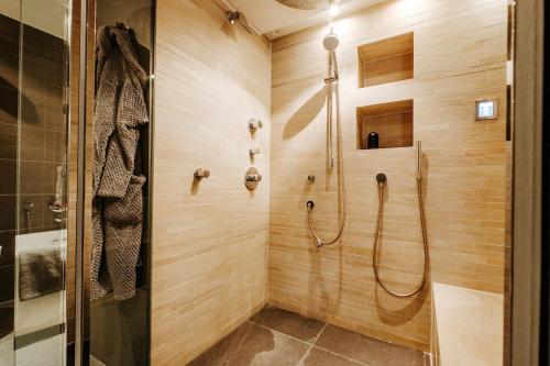 a bathroom with a shower with a glass door at Sauna cottage in Tielt