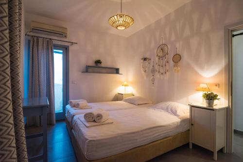 a bedroom with two beds with towels on them at Villa Allegra in Kythira