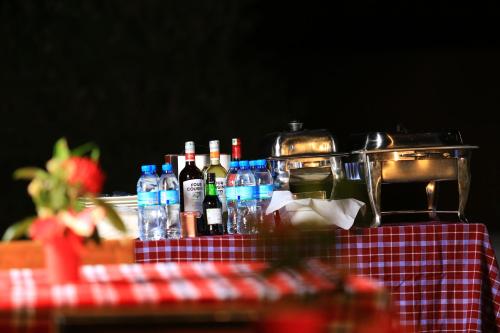 a table with bottles of wine and glasses on it at Mlangoni Cottages in Sanya Juu