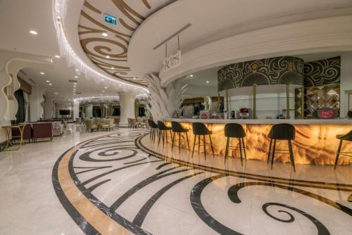 a lobby with a bar in a building at Adalya Elite Lara Hotel - Ultra All Inclusive in Lara