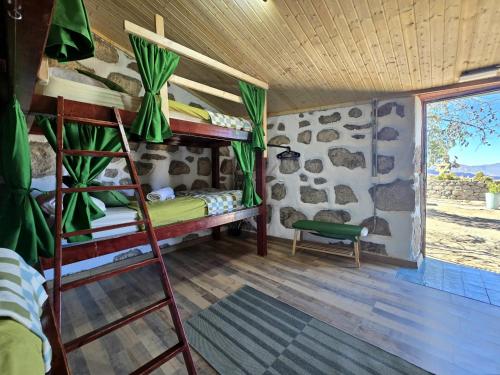 a room with two bunk beds and a window at Mountain Hostel&House Finca La Isa by Rose in Tejeda
