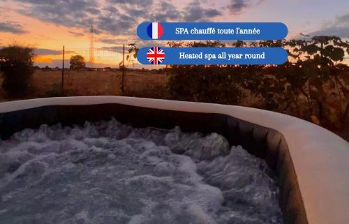 a bath tub filled with snow in front of a sunset at Villa Safari, Golf & Spa - Toulouse in Plaisance-du-Touch