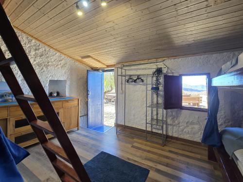a room with a shower and a tv in a room at Mountain Hostel&House Finca La Isa by Rose in Tejeda