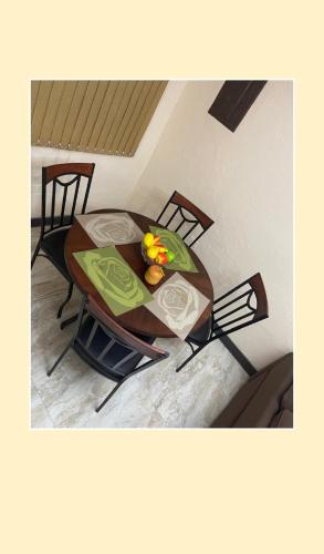 a rendering of a table with chairs around it at Perfect vibez in Portmore