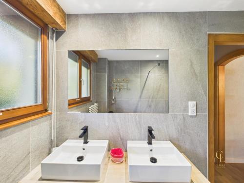 two white sinks in a bathroom with a mirror at ⁂⁂ GITE LE PRES AU CERF [CLEDICIHOME] 2 steps from the LISPACH resort // PRIVATE toboggan run! SNOWSHOE DEPARTURE ⁂⁂ in La Bresse