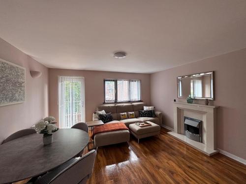 a living room with a couch and a table at FREE parking - modern apartment in SW London in Merton
