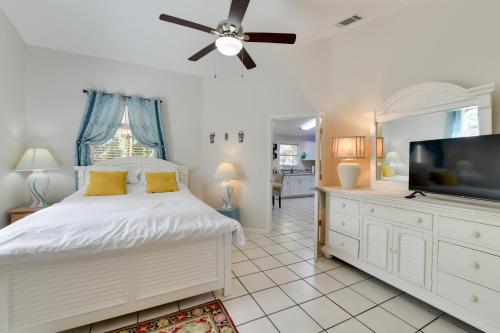 a bedroom with a bed and a flat screen tv at Couples Getaway Near Historic Downtown Venice! in Laurel