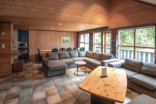 a living room with a couch and a table at Bakkebyvegen 13B in Trysil