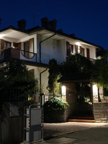 a white house with a sign in front of it at 40zero24 in Castel San Pietro Terme