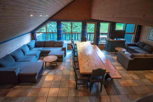 a living room with blue couches and a wooden table at Bakkebyvegen 13A in Trysil