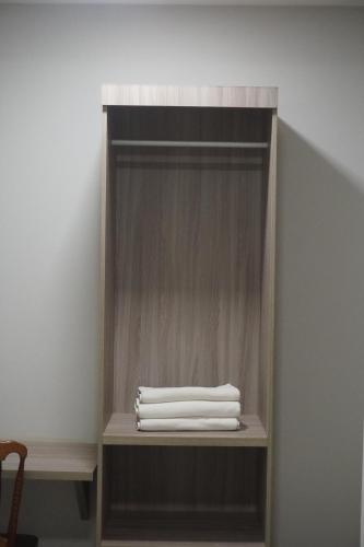 a wooden shelf with white towels on it at Hotel Portal dos Cerrados in Uruçuí