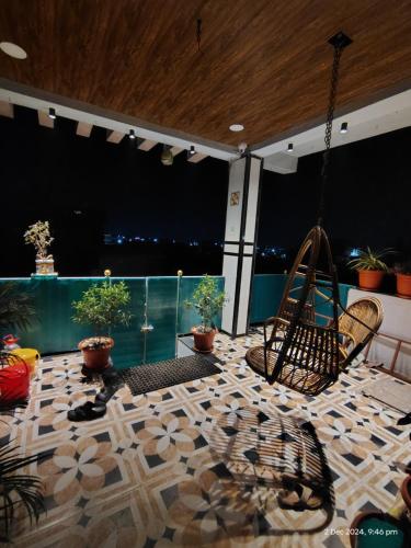 a balcony with a swing and potted plants at Shree Datt Yatri Niwas Akkalkot in Solapur
