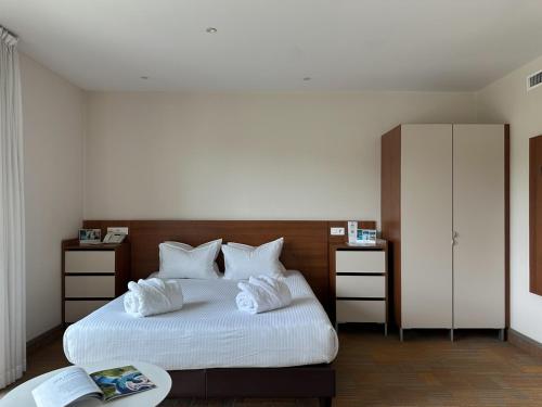 a bedroom with a bed with two white pillows at Hôtel Lyon Métropole in Lyon