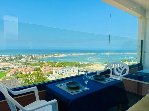a dining table with a view of the ocean at La coline vue sur mer Uniquement les familles in Oualidia
