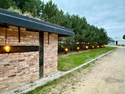 a brick building with lights on the side of it at DomkiTomki, Winnica Sindaco in Biskupice