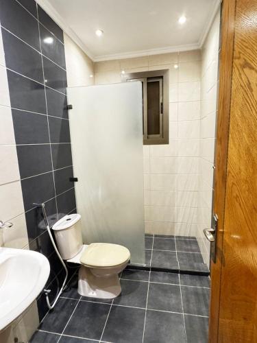 a bathroom with a toilet and a sink at لارين سويتس in Jeddah
