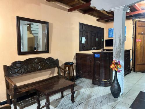 a living room with a piano and a vase of flowers at Hotel Corazon de Granada in Granada