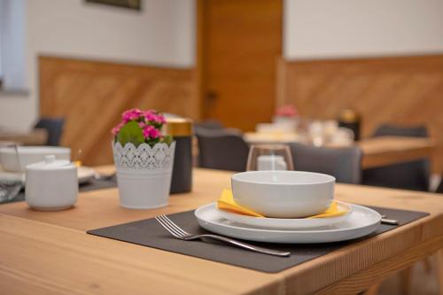 a table with a bowl and a plate on it at La Douce Pomme in Saint-Pierre