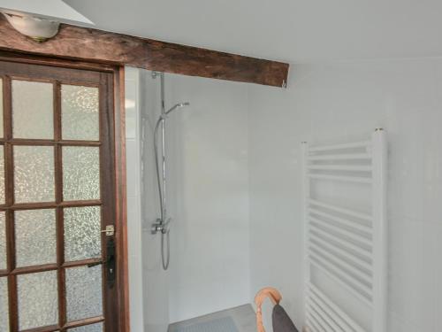 a shower in a bathroom with a window at Maswari en Drapeau in Lusignac